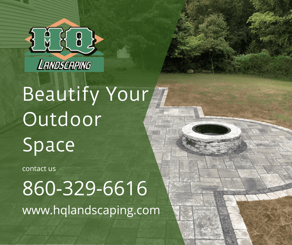 HQ Landscaping promotional image featuring a well-designed hardscape patio with a circular stone firepit, highlighting landscaping services in Connecticut.